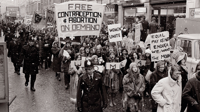WLM protest with a banner calling for free contraception and abortion on demand