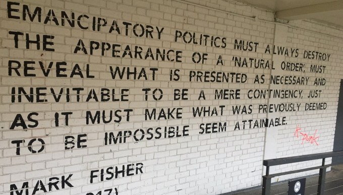 Mark Fisher quote about emancipatory politics on wall