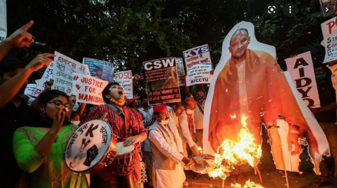 Protesters burn an effigy of UP chief minister Adityanath