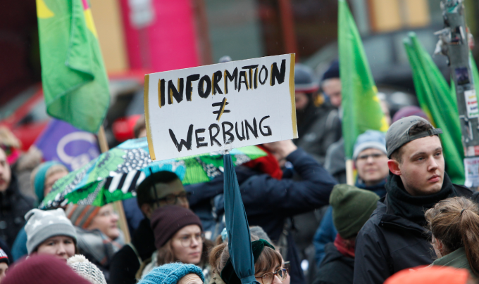 Placard reading "information =/= werbung"