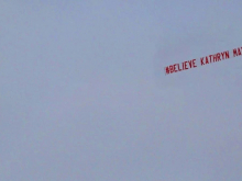 'Believe Kathryn Mayorga' banner
