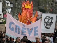 A large banner with the French word "grève", meaning "strike" written on it