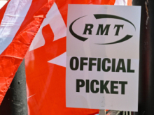 RMT official picket placard in front of a red RMT flag