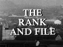 Black-and-white photograph of buildings, with overlaid white text reading "The Rank and File"
