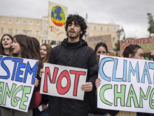 "System change not climate change" placards