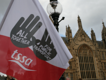 A red and white TSSA flag with the slogan "all together for public transport"