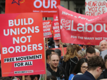 "Build Unions Not Borders" placard