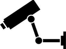 Black silhouette of a CCTV security camera mounted on an adjustable wall bracket, shown against a white background.