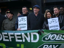 An RMT picket line, with people holding up "RMT official picket" placards
