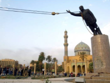 Saddam Hussein comes down