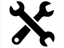 Black silhouette icon of two crossed wrenches on a white background, symbolising tools, maintenance, or settings.