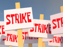A cartoon of placards with the word "strike" written on them in red letters