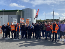 A group of strikers some with orange GMB placards