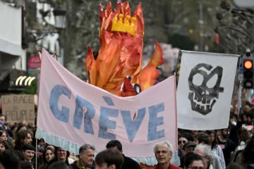 A large banner with the French word "grève", meaning "strike" written on it