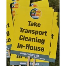 Yellow placards reading "Take Transport Cleaning In-House", with an RMT "Justice for Cleaners" logo