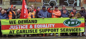 Striking RMT members with a union banner reading "WE DEMAND JUSTICE & EQUALITY FOR CARLISLE SUPPORT SERVICES WORKERS"