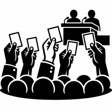 Silhouette-style icon of a public vote or assembly. Several raised hands hold voting cards in front of a crowd, while two speakers sit at a podium with microphones, suggesting a meeting, conference, or democratic decision-making process.