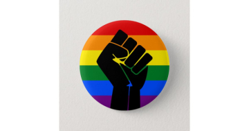 Raised fist on a rainbow background