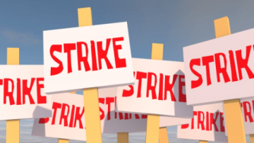 A cartoon of placards with the word "strike" written on them in red letters