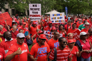 A large crowd of union member in red t-shirts protest the Trump government's sackings of public sector workers