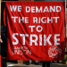 A large red banner with the slogan "We demand the right to strike" and "Lambeth Unison" embroidered on it