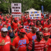 A large crowd of union member in red t-shirts protest the Trump government's sackings of public sector workers